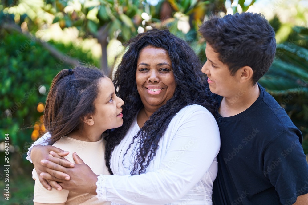 African american family hugging each other at park African american family hugging each other at park