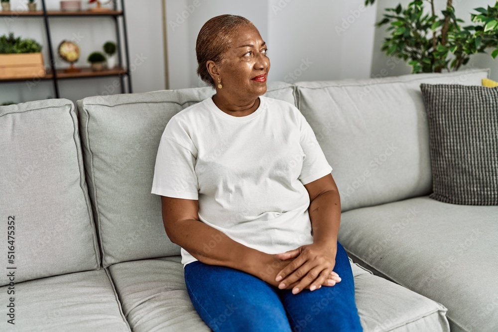 Senior african american woman smiling confident sitting on sofa at home Senior african american woman smiling confident sitting on sofa at home
