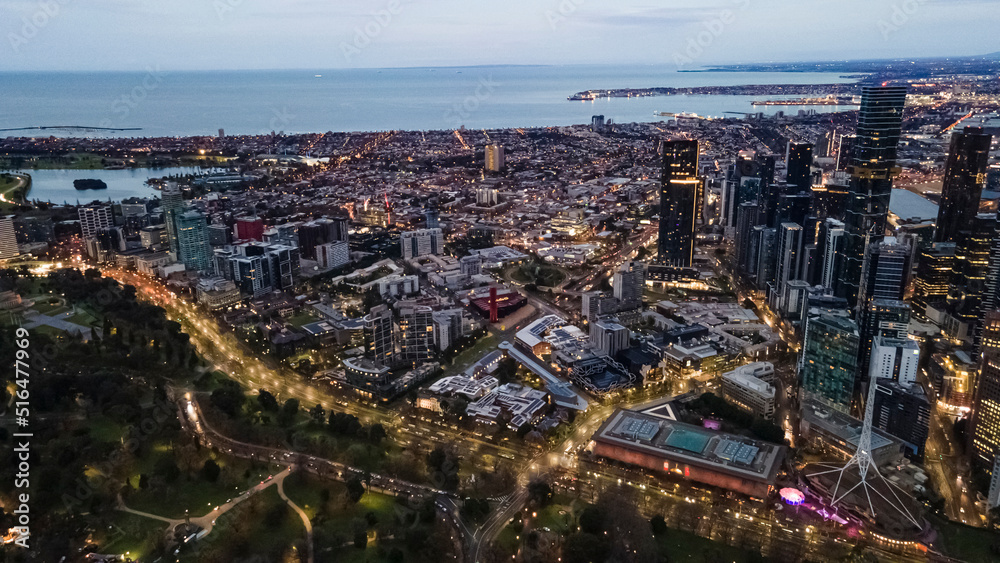 Aerial drone view of Melbourne City, Victoria, Australia looking in the direction of Port Phillip above Yarra River in the early morning at dawn 