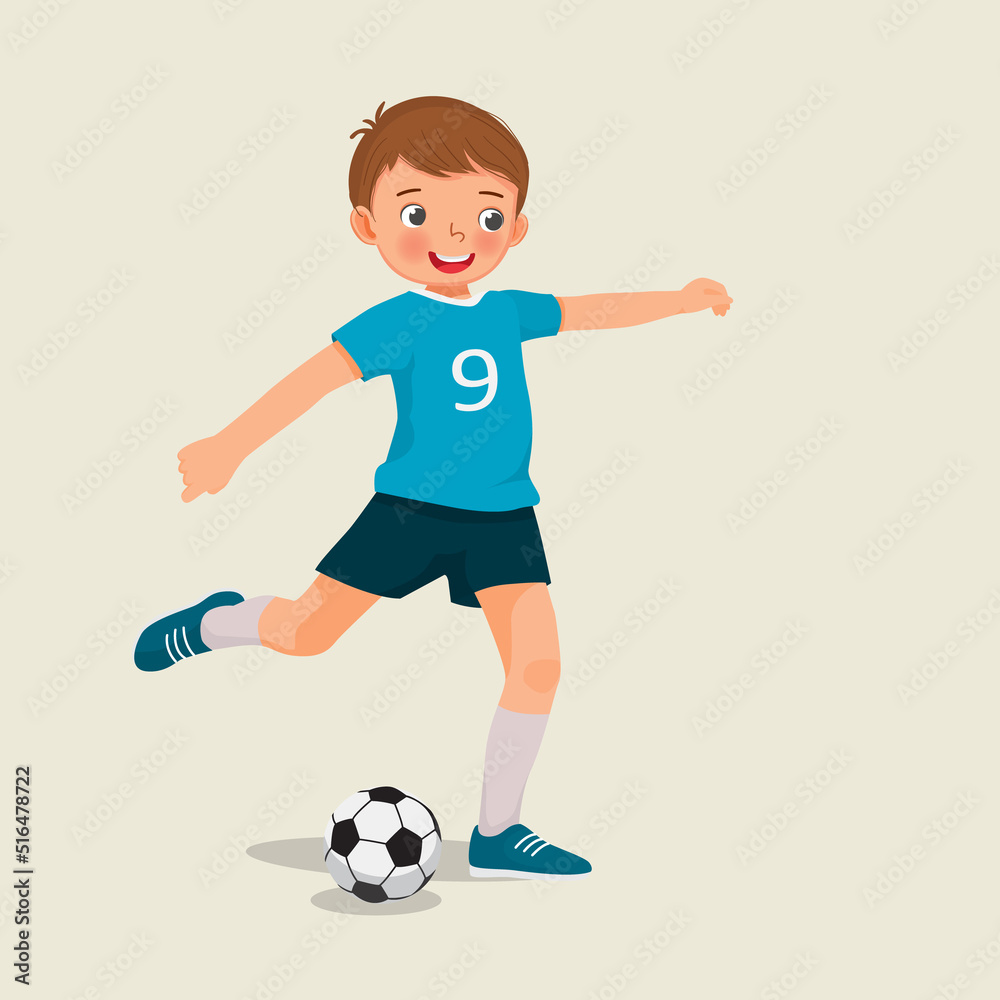cute little boy playing soccer kicking the football to make a goal