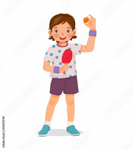 Cute little girl table tennis player holding ping pong ball with paddle ready to play