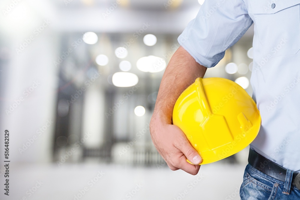Engineer man holding hardhat work helmet hard hat for Civil Construction Engineering. Construction engineer man Engineer man holding hardhat work helmet hard hat for Civil Construction Engineering. Construction engineer man
