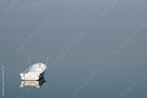 Unmanned drifting boat in the middle of a lake.