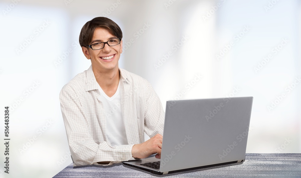 Young man work using computer hand typing laptop keyboard. student study learning education online