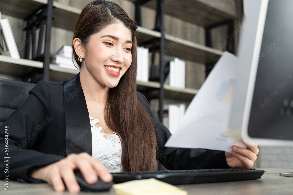 Portrait of pretty business woman using computer at workplace in an office. positive business lady smiling looking on paper. Portrait of pretty business woman using computer at workplace in an office. positive business lady smiling looking on paper.