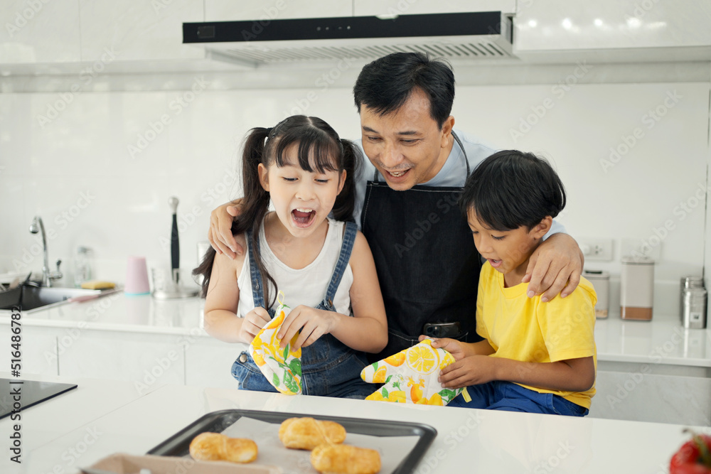 Happy asian family enjoy playing and cooking in the home kitchen. Happy asian family enjoy playing and cooking in the home kitchen.
