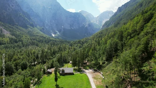This is Logar Valley in Slovenia, and it is one of the most beautiful Alpine glacial valleys found in Europe. The valley is covered with rocky mountains and dense forests. photo