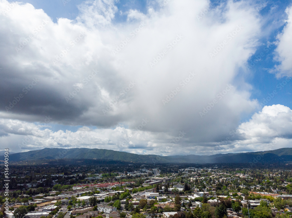 Obraz premium Puffy white clouds over suburbia, May 2022
