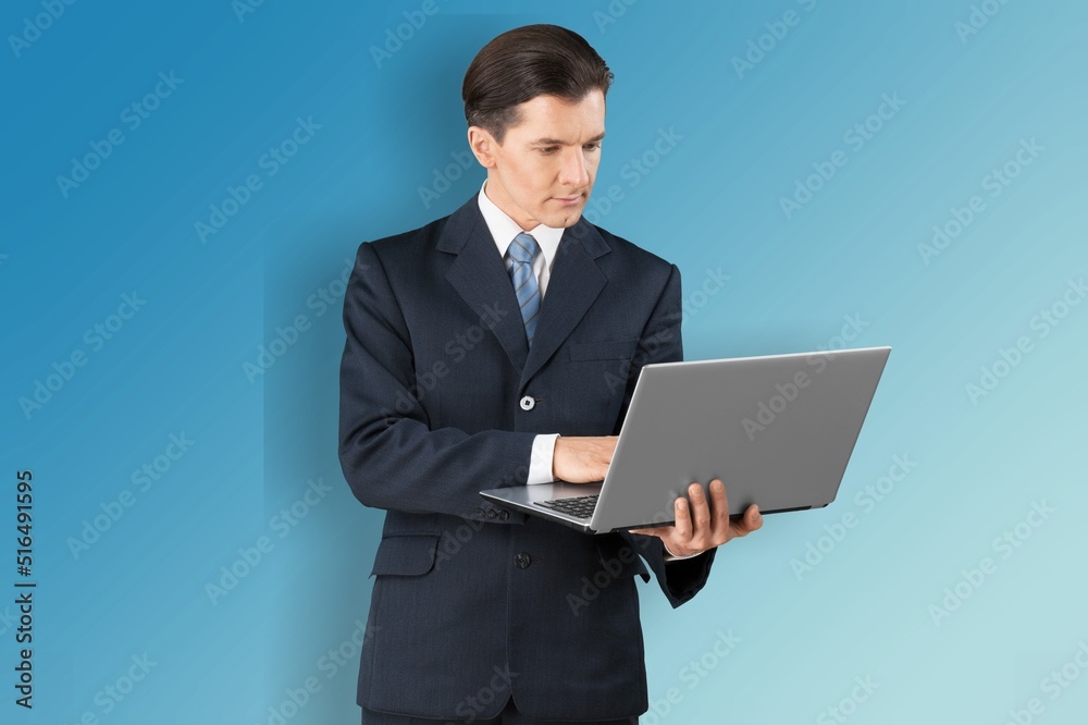 Optimistic male student or worker using laptop pc