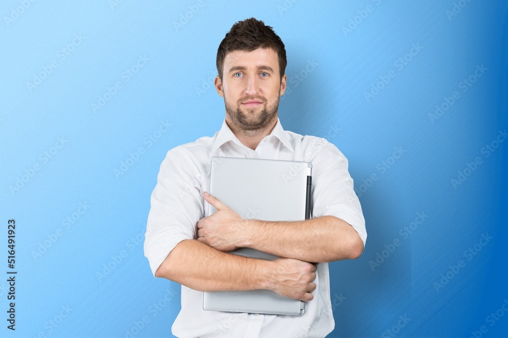 Optimistic male student or worker using laptop pc