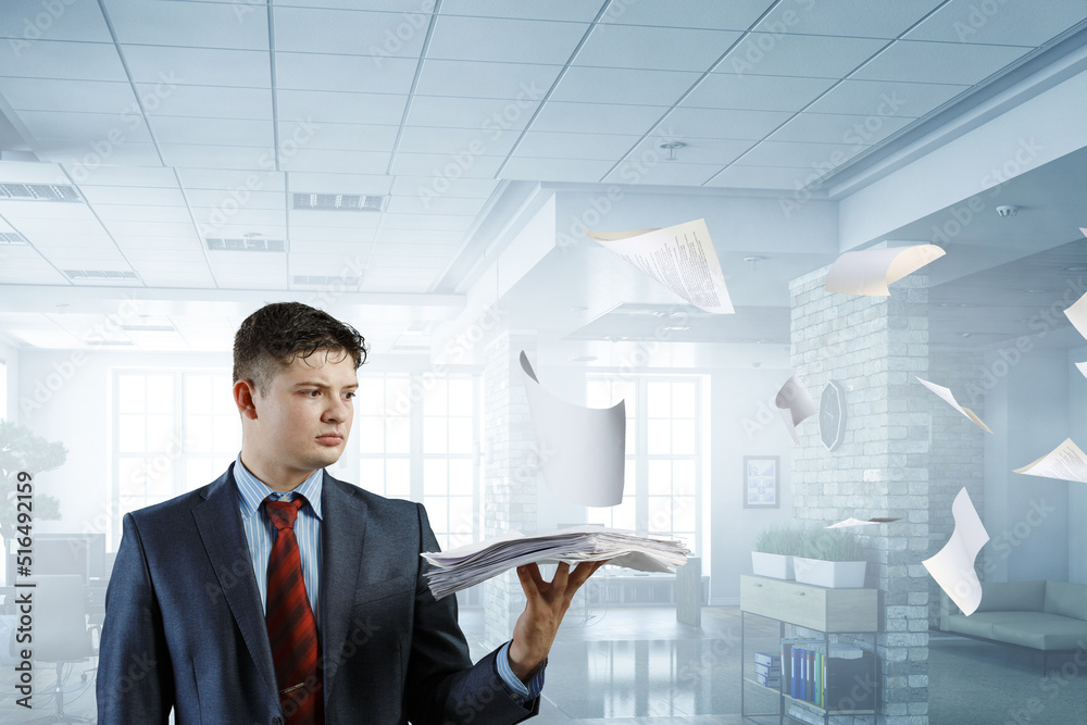 Fototapeta premium Business Concept - handsome young professional businessman holding report papers