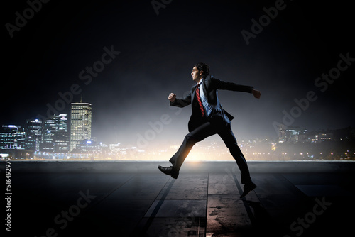Portrait of energetic businessman running © Sergey Nivens