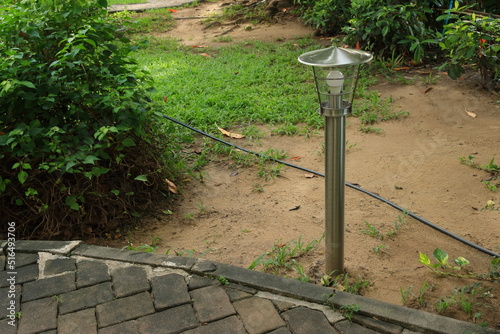 Lamp post with LED energy saving bulb in garden