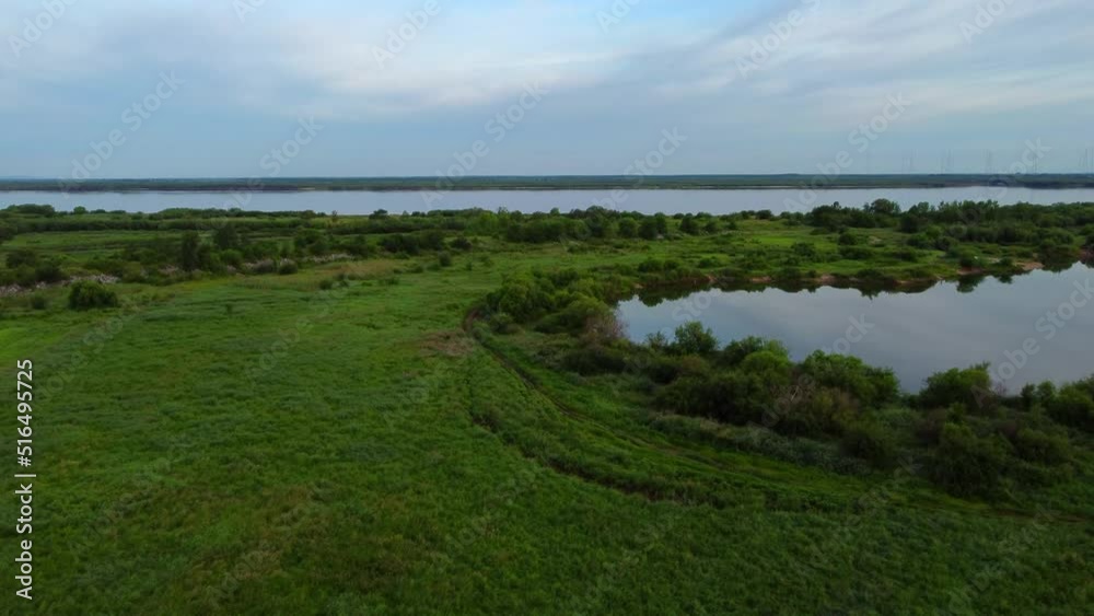 It's early morning before sunrise. A lake on Bolshoy Ussuriysky Island and the Amur River in the Khabarovsk Territory in Russia. It's early morning before sunrise. A lake on Bolshoy Ussuriysky Island and the Amur River in the Khabarovsk Territory in Russia.