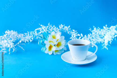 Fototapeta Naklejka Na Ścianę i Meble -  プルメリアの花束とコーヒーと白い葉（スマイラックス）のデザイン（ブルーバック）	
