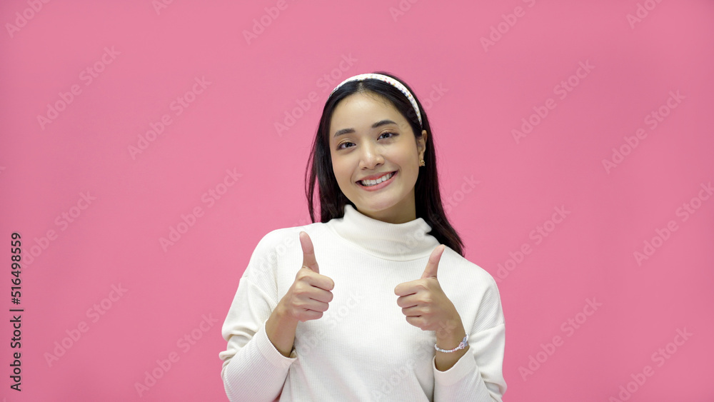 Asian woman smiling and giving thumbs up with joy and excitement. Asian woman smiling and giving thumbs up with joy and excitement.