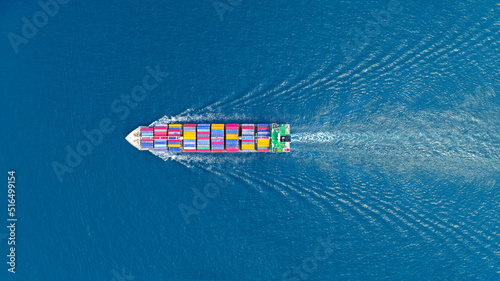 Aerial top view of cargo maritime ship with contrail in the ocean ship carrying container and running for export concept technology freight shipping sea freight by Express Ship