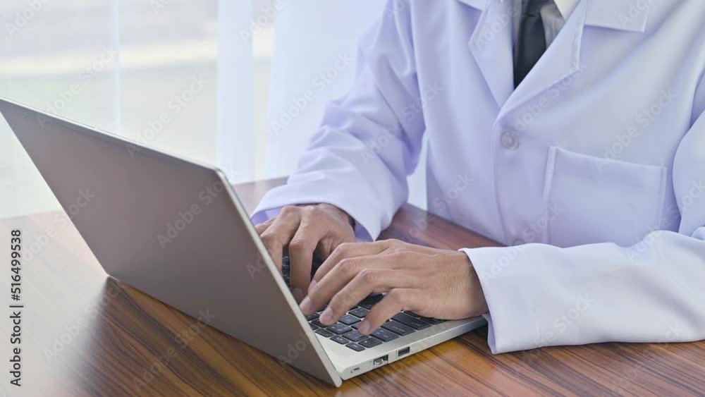 Doctor working with computer notebook in hospital office, Healthy medical concept