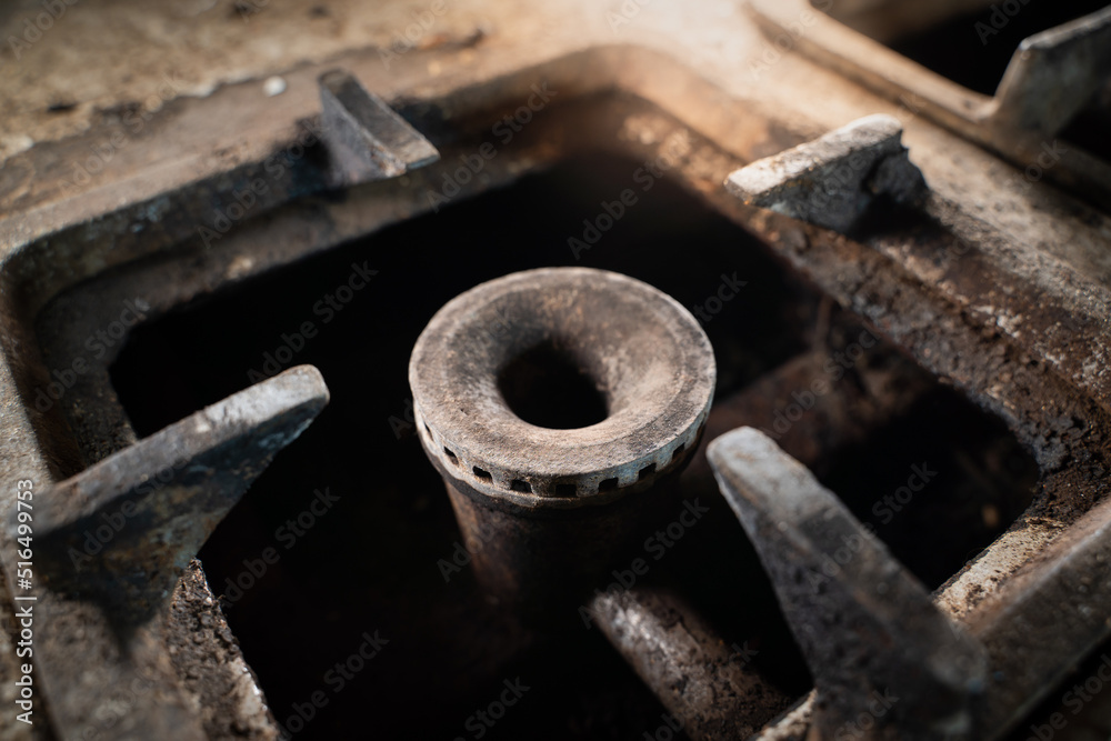 Dirty rusty gas burner of an old gas stove