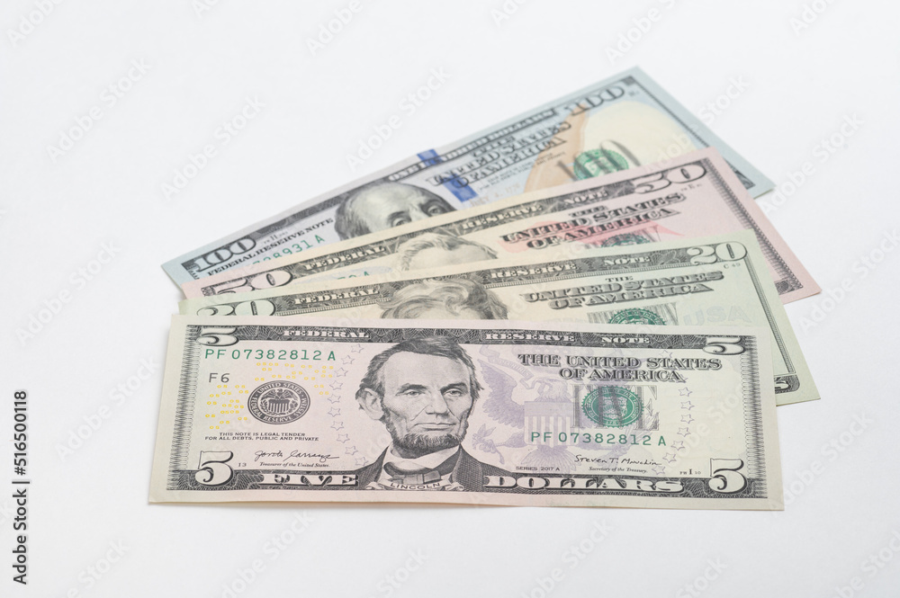 5, 20, 50, 100 dollars banknotes at different angles. Close up of dollars on white background. 5, 20, 50, 100 dollars banknotes at different angles. Close up of dollars on white background.