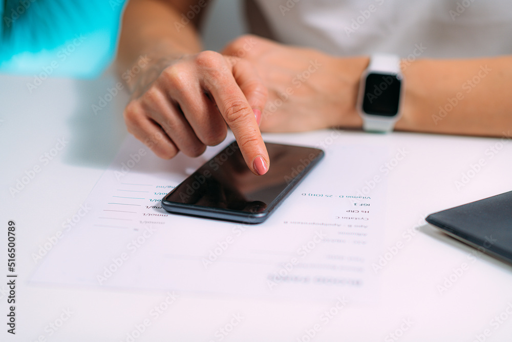 Woman Using Smart Phone Application for Blood Panel List Woman Using Smart Phone Application for Blood Panel List