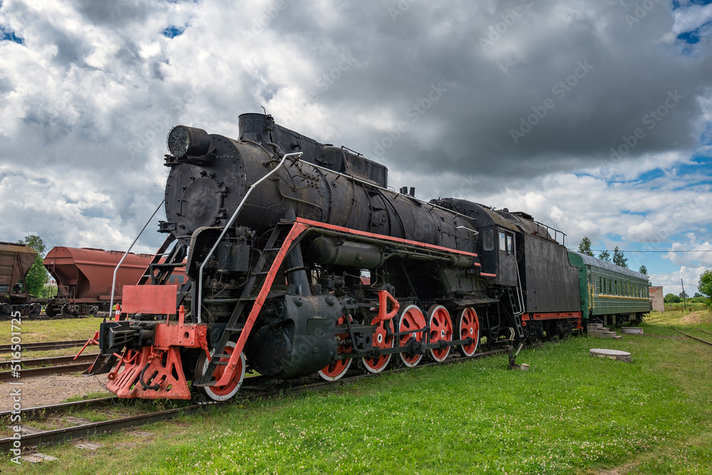 An old steam locomotive rests on the siding. An old steam locomotive rests on the siding.