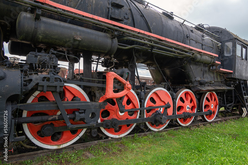 An old steam locomotive rests on the siding.