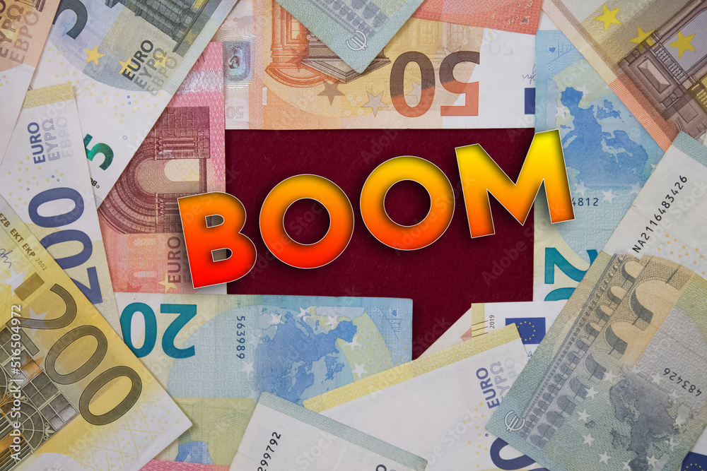 Boom word with money. Paper currency background with different banknotes. Boom word with money. Paper currency background with different banknotes.
