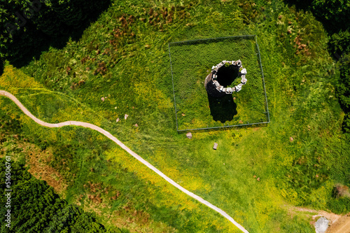 Old stone tower by a green forest in county Tipperary, close to Devil bit mountain. Ireland. Old history building preservation. photo