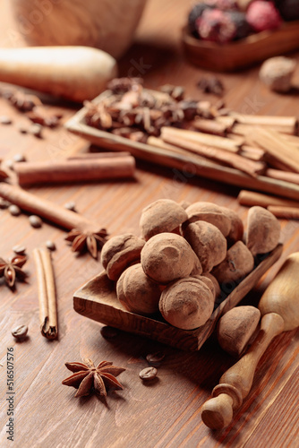 Chocolate truffles on a wooden table.