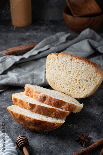 Freshly baked homemade bread with crispy crust on gray stone background