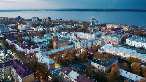 City at sunset. Aerial view of the city of Petrozavodsk and Onega lake in Russia during twilight. Drone flight over the night city photo