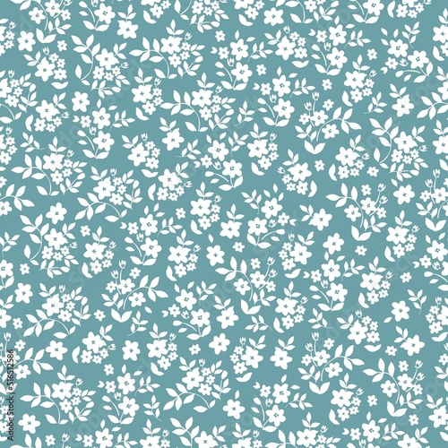 Simple vintage pattern. small  white flowers and leaves. blue  background. Fashionable print for textiles and wallpaper.