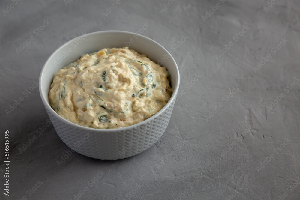 Homemade Caramelized Onion and Spinach Dip, side view. Space for text. Homemade Caramelized Onion and Spinach Dip, side view. Space for text.