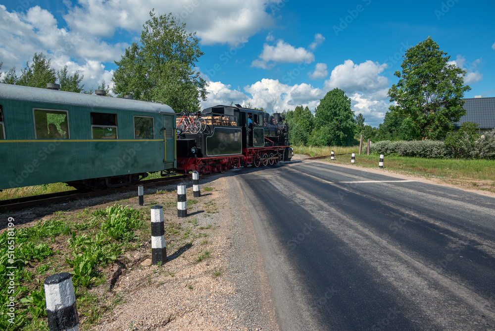 Naklejka premium Narrow gauge train with a steam locomotive on the line Gulbene - Aluksne, Latvia.