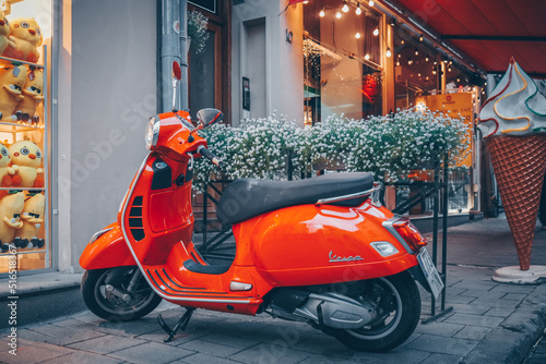 Red motorcycle at the entrance to the cafe. Atmospheric street photo photo