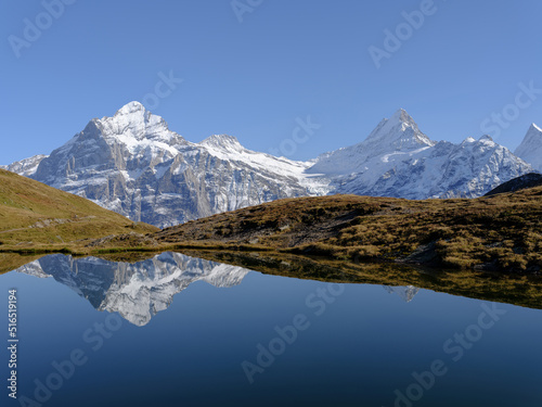 Rocky mountains and reflection on the surface of the lake. Landscape in Grindelwald, Switzerland.