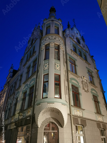 An old house with beautiful windows and walls on one of the streets of Old Tallinn against the blue sky. Spring evening. Kesklinn photo