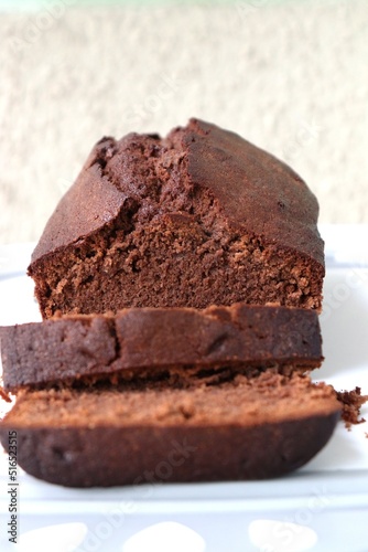 Perfectly baked homemade chocolate sponge cake using Flour, sugar, butter, baking powder, salt, eggs, and cocoa powder. Copy space. bakery concept. Moist sponge cake slice with texture.