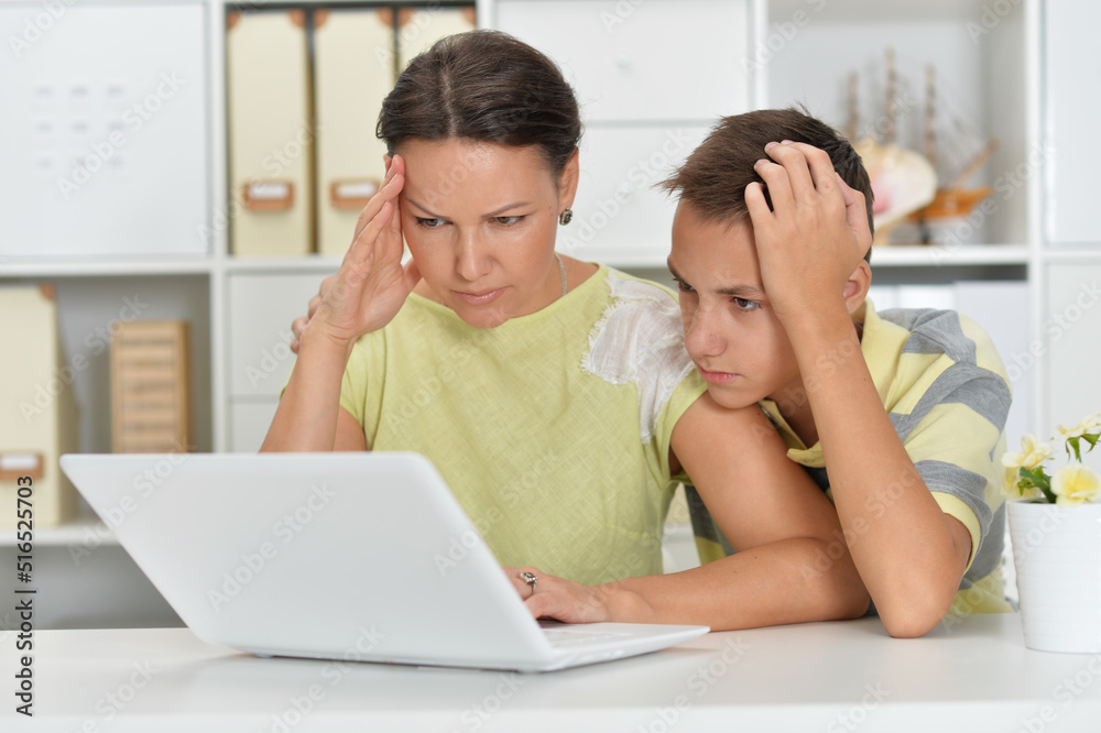 mother and son using modern laptop