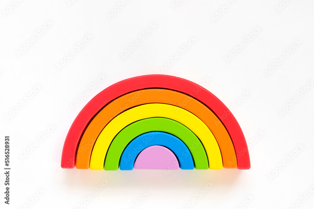 Obraz premium Wooden rainbow isolated on a white background. The rainbow toy puzzle. LGBT flag gay pride community, equal rights movement and gender equality life concept. Flat lay, top view, copy space