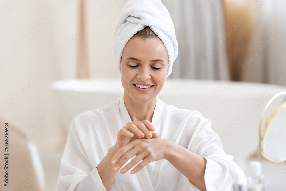 Attractive lady using hand cream after shower Attractive lady using hand cream after shower