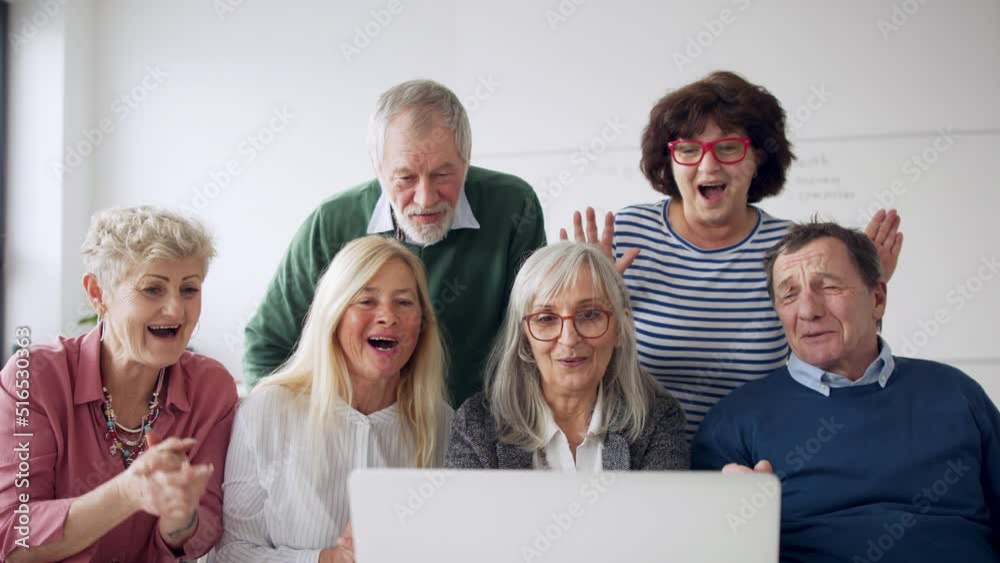 Group of cheerful seniors attending computer and technology education class. Group of cheerful seniors attending computer and technology education class.