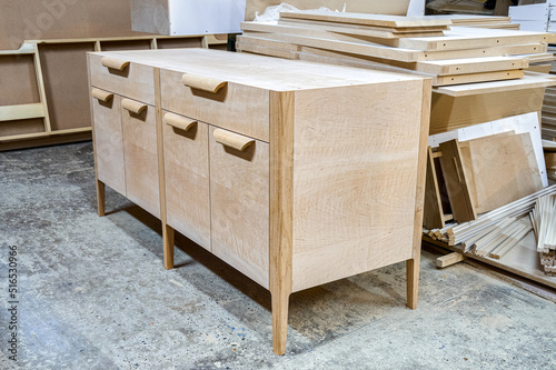 Chest of drawers made of solid alder in process of production at workshop. Creation of modern domestic furniture for bedroom interior