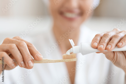 Konstfotografi Cropped of woman squeezing toothpaste on toothbrush