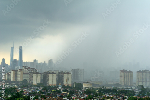 View of Kuala Lumpur city skyline during monsoon season. It usually happens between April and September. The summer monsoon brings a humid climate and torrential rainfall to these areas.
