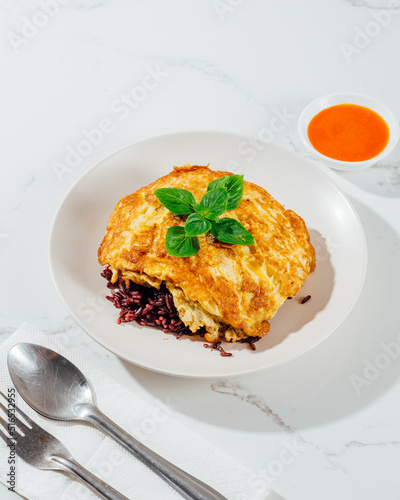 Thai traditional omelets stuff minced pork on top streamed rice, fast food, Thailand.