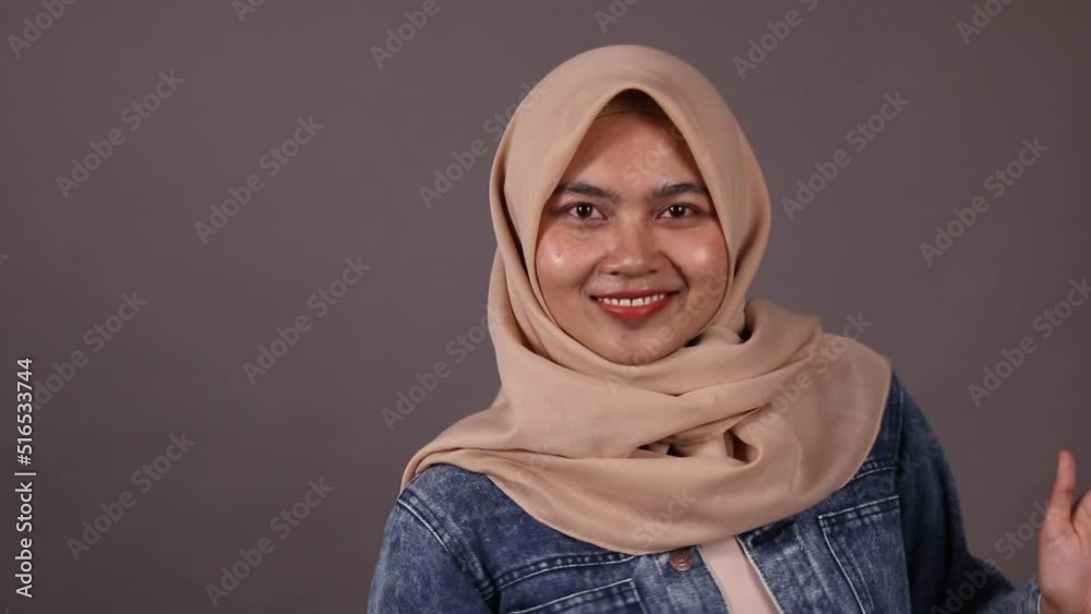Fashion portrait of young beautiful asian muslim woman with wearing hijab isolated on grey background. Closeup beauty shoot.
