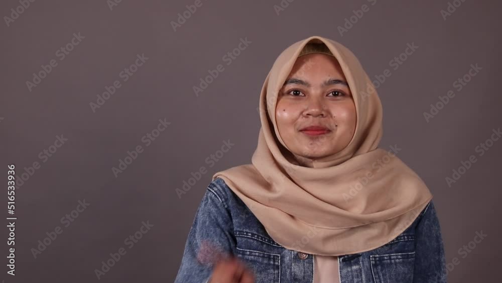 Asian woman dont want people knowing her secret. Keep a secret gesture isolated gray background. Asian woman dont want people knowing her secret. Keep a secret gesture isolated gray background.