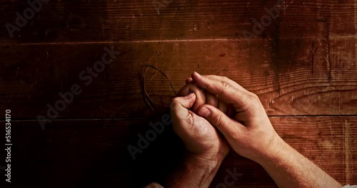 A Christian opens his palm with a cross